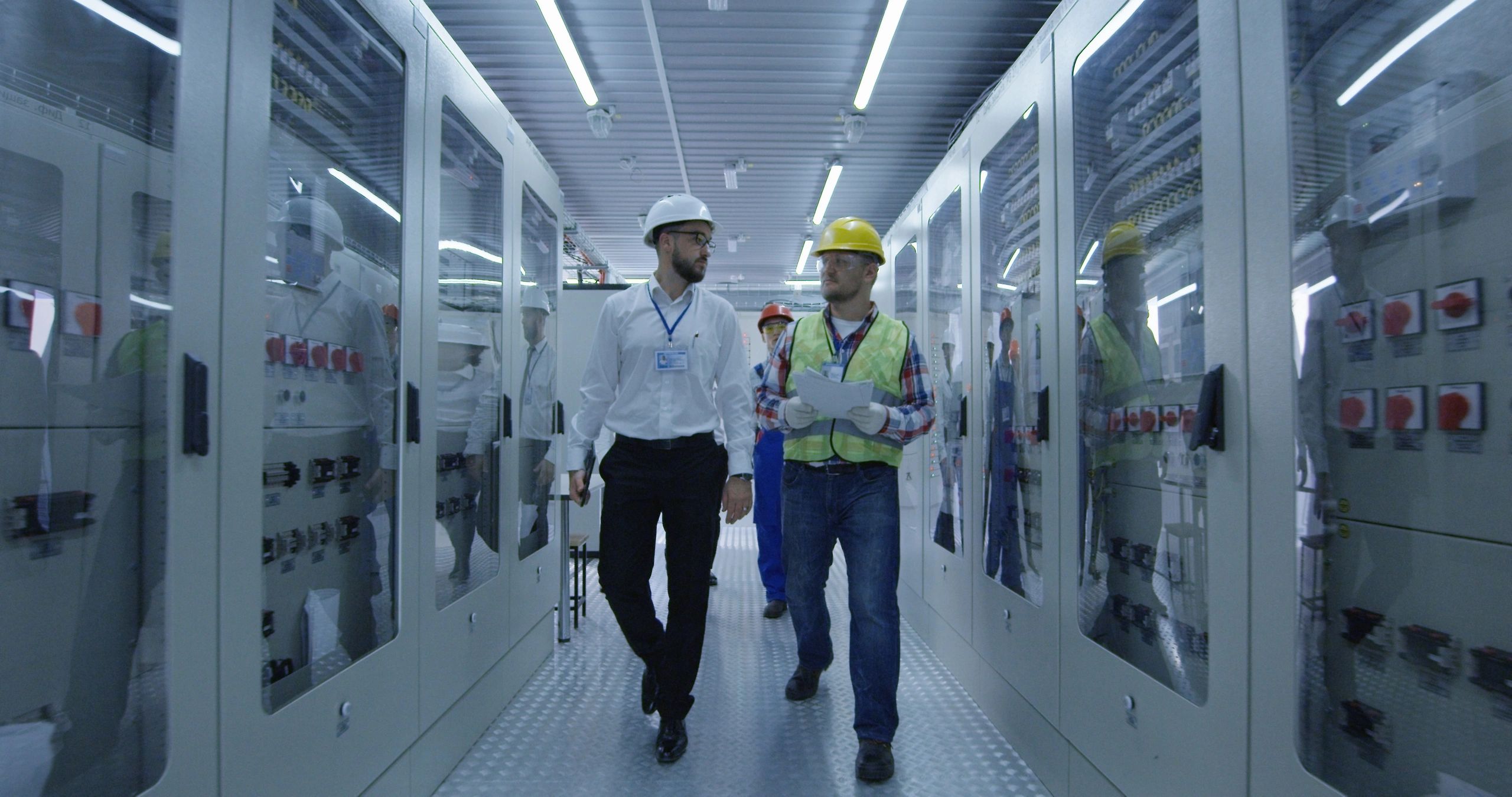Technical workers reviewing systems in a control room