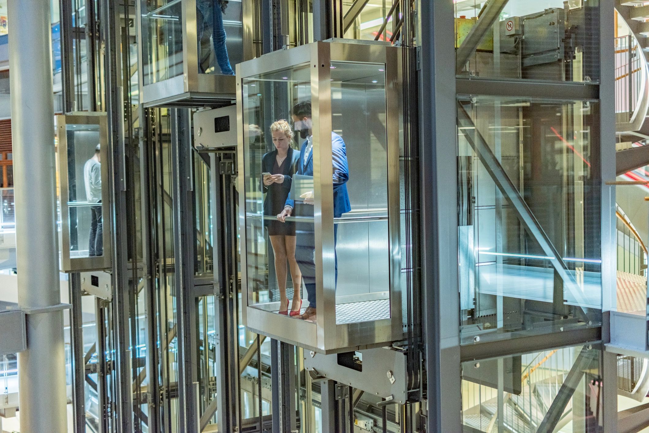 Business professionals inside an elevator